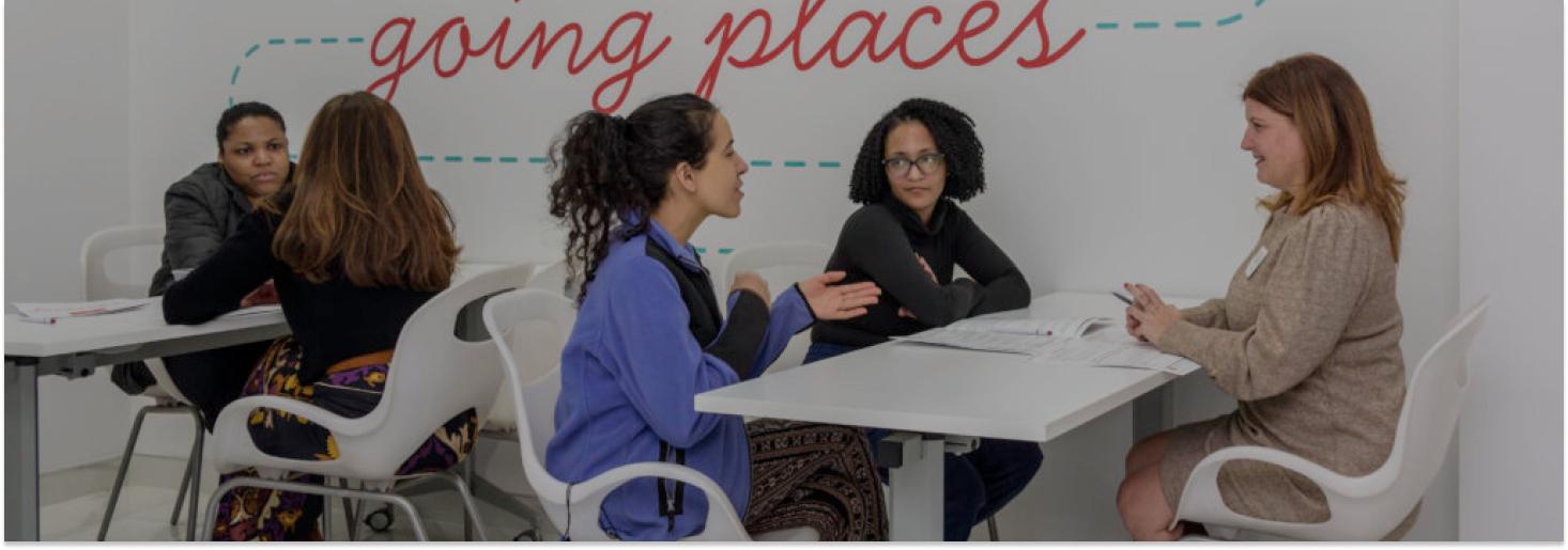 Women meeting around tables to discuss employment